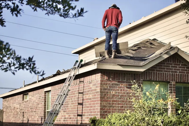 Professional roofer working on a residential roof in Media